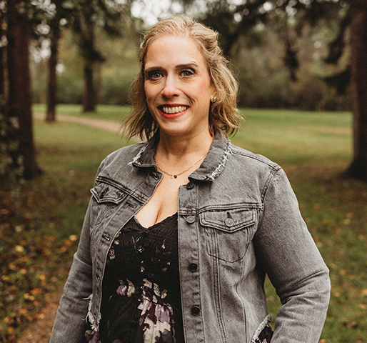 Jessy Wetsch's professional headshot with her wearing a black flowered blouse and grey, jean jacket.