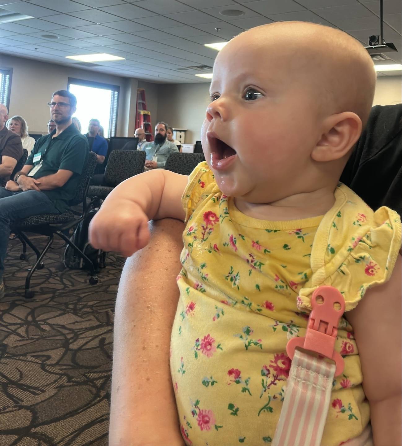 Raulie Berthold’s baby girl, KoDee, excited and engaged during an AI discussion as part of NDIT’s monthly Fireside Chat.