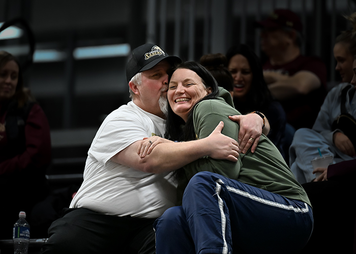 An adorable jumbotron moment of Tony Aukland kissing his wife, Donna, on the cheek during a basketball game.