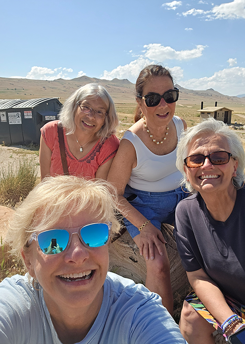 Julie Arp and three of her female NASTD colleagues happily pose for a selfie while enjoying the outdoors on a sunny day.