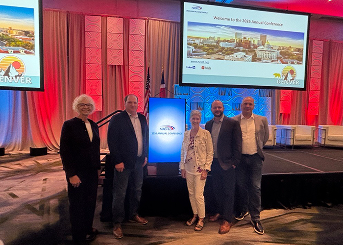 Julie Arp and a few of her fellow NDIT team members pose for a group picture at the NASTD Annual Conference.