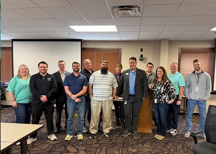 Tina Radenz poses for a picture with members of NDIT’s Security team during a cyber training exercise in Bismarck, ND.