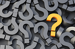 Decorative image of question marks arranged all different directions with one being orange.
