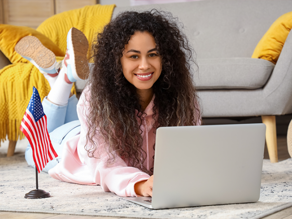Woman laying on the floor with her laptop.