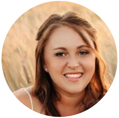 Raulie Berthold, Executive Assistant & Project Coordinator, has long, curly light brown hair, set against a softly blurred field background.