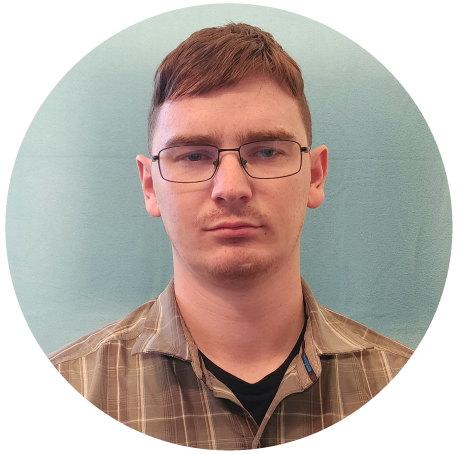 Chase Berry, Cybersecurity Analyst, has short brown hair, a light mustache, and wire-framed glasses, wearing a brown collared shirt.