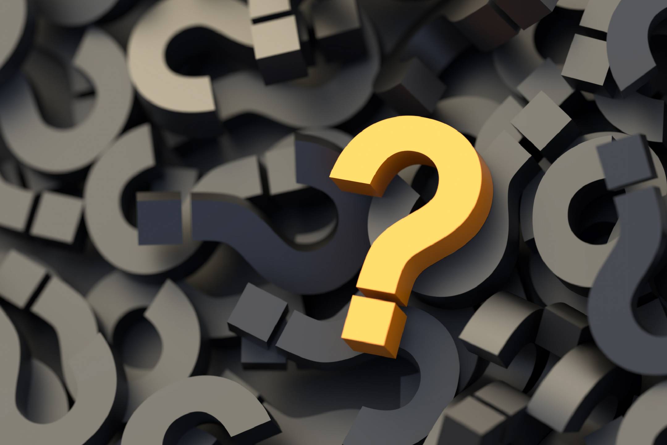 A lone yellow question mark in in a sea of dark-colored question marks.