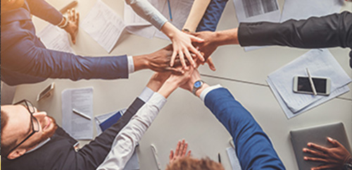 About Us News Image showing hands in a circle